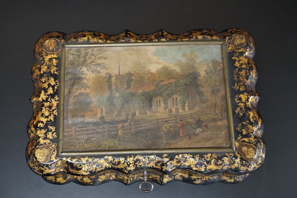 A Victorian Papier mache japanned sewing box, stamped ‘Lane, Birmingham’, the cover with a view of Chingford old church Essex, a boxed Victorian French translation game, by E C Spurin and a papier mache panel (3)